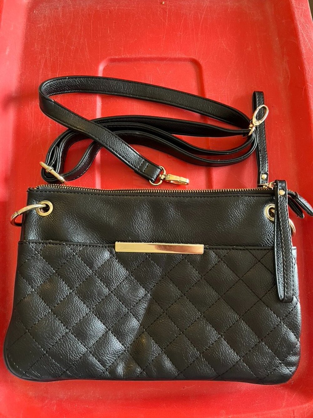 Black faux leather purse with animal print interior